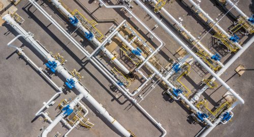 Aerial top view natural gas pipeline, gas industry, gas transport system, stop valves and appliances for gas pumping station.